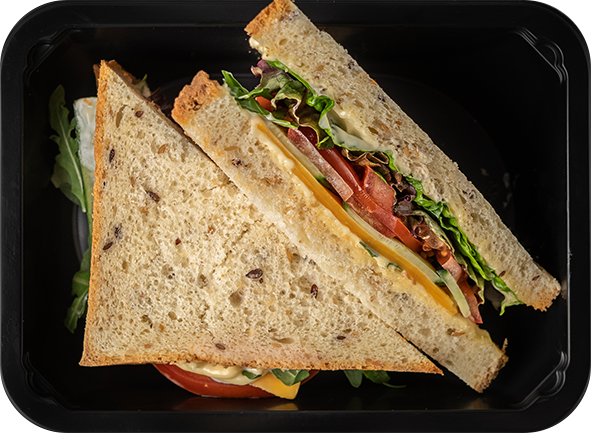Сэндвич на бездрожжевом хлебе с сыром "Чеддер" и кольцами томатов с рукколой